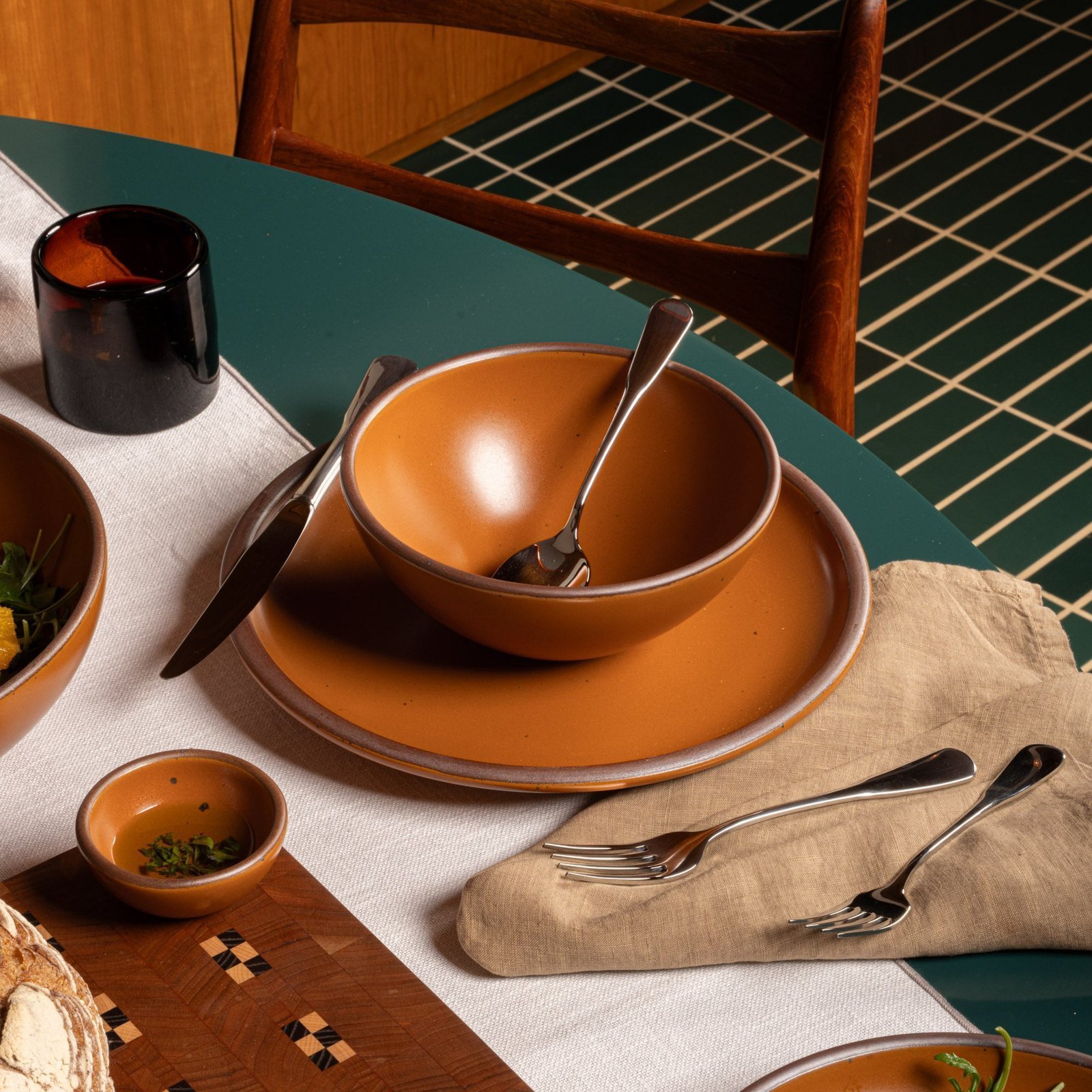 Ember Heova soup bowl in a table setting with other dinnerware