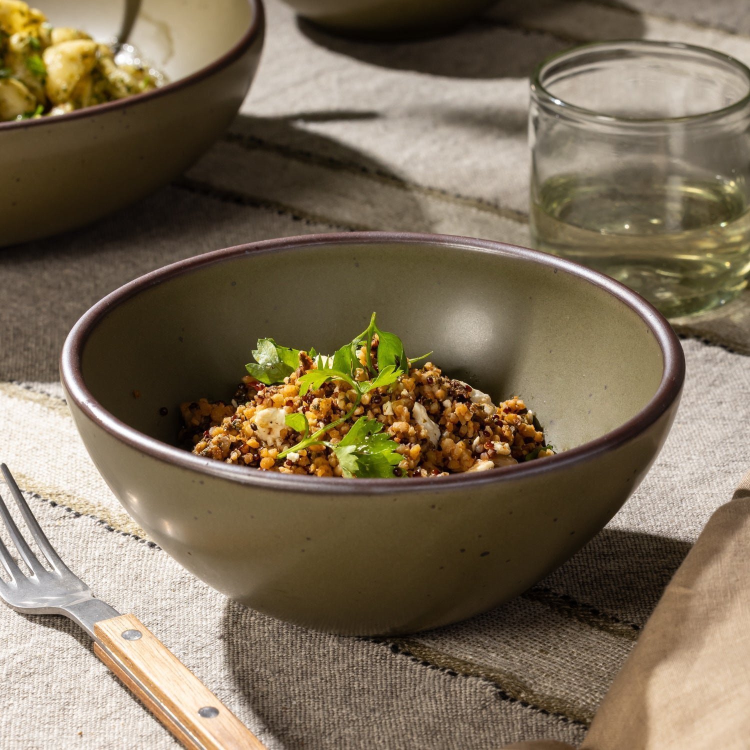 Pine Green Heova soup bowl with a grain dish